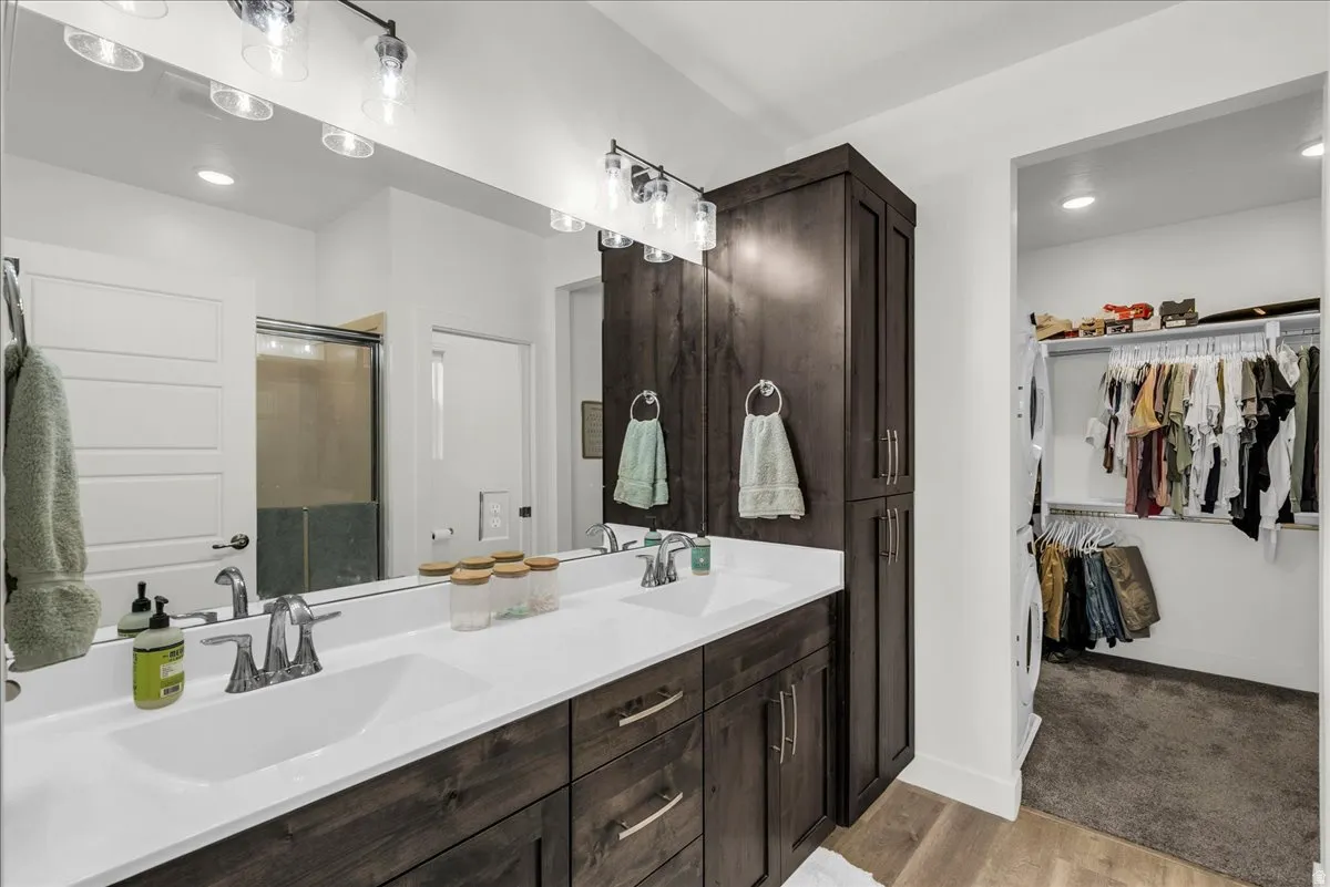 Dual vanity with white countertops and dark wood-finish cabinetry