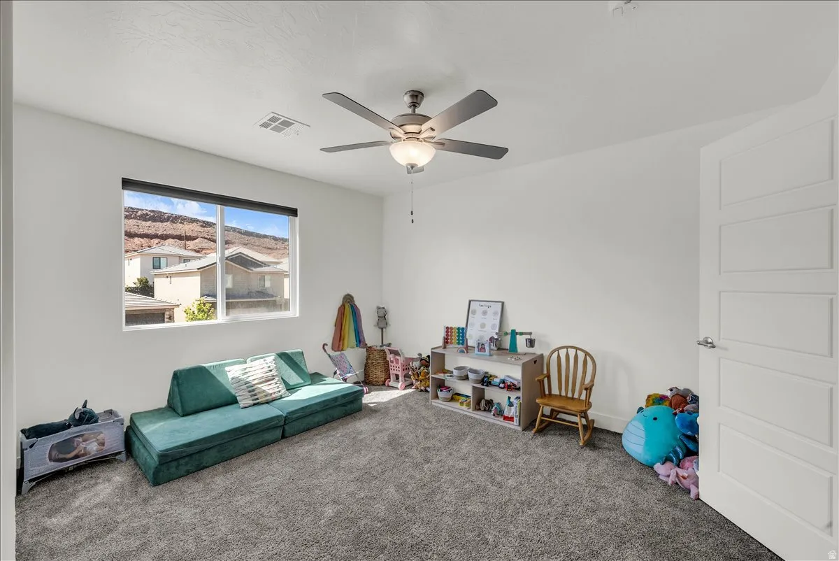 Spacious room with light gray carpet and white walls