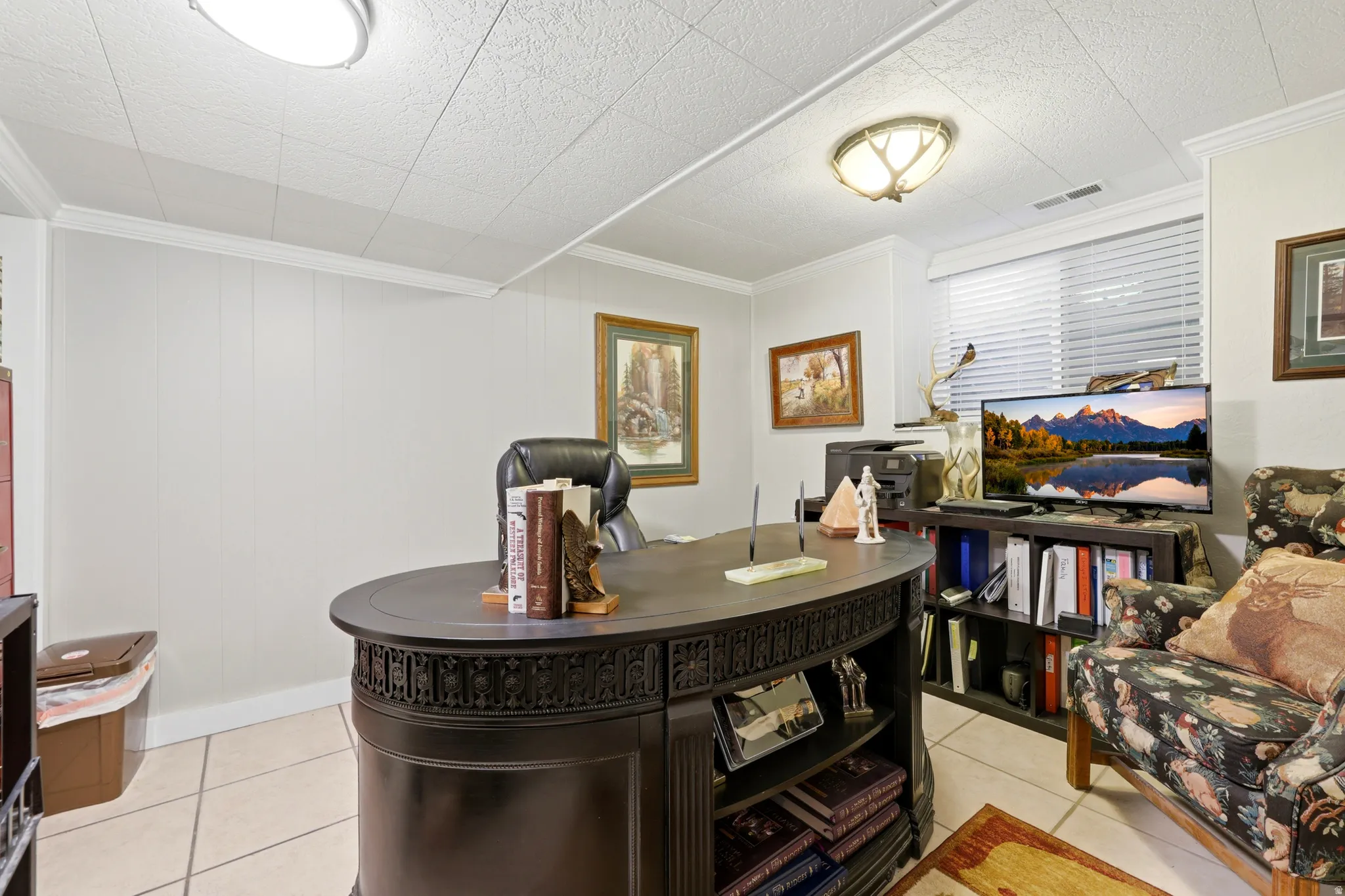 Dedicated room featuring white paneled walls, tile flooring, and two recessed ceiling lights