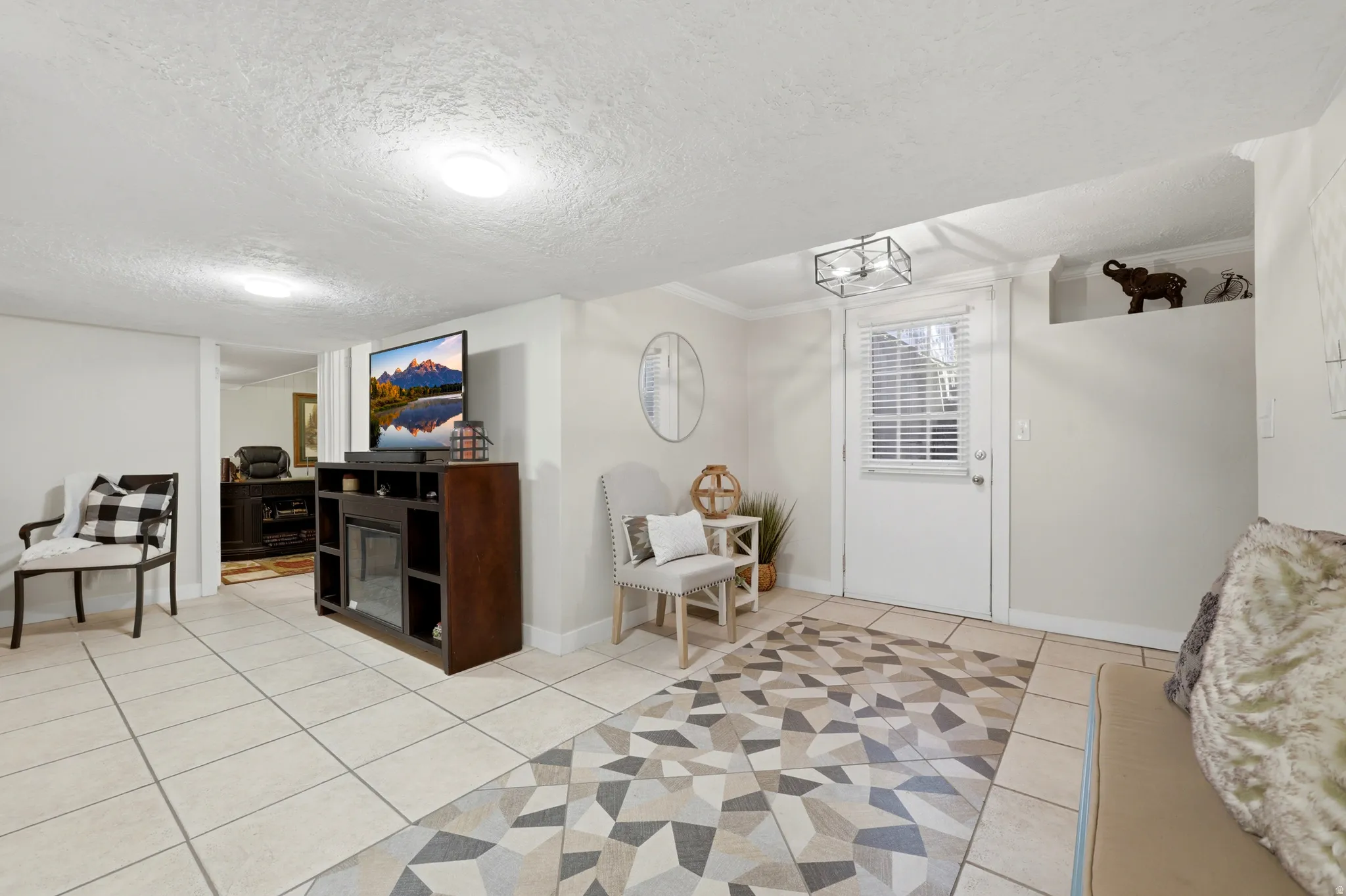 Spacious room featuring tile flooring, white walls, and a built-in recessed shelf