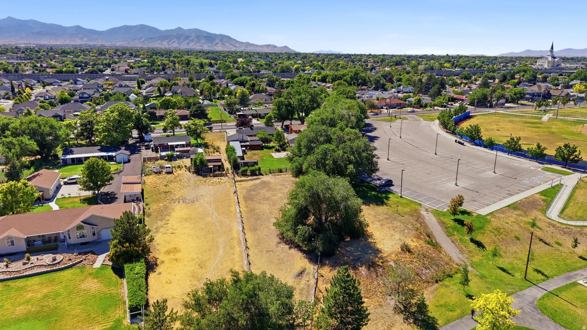 Expansive lot with potential for development, featuring varied terrain and mature trees