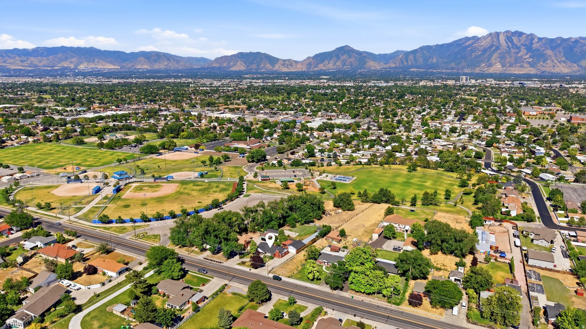 Expansive aerial perspective showcasing a residential area with a prominent mountain backdrop