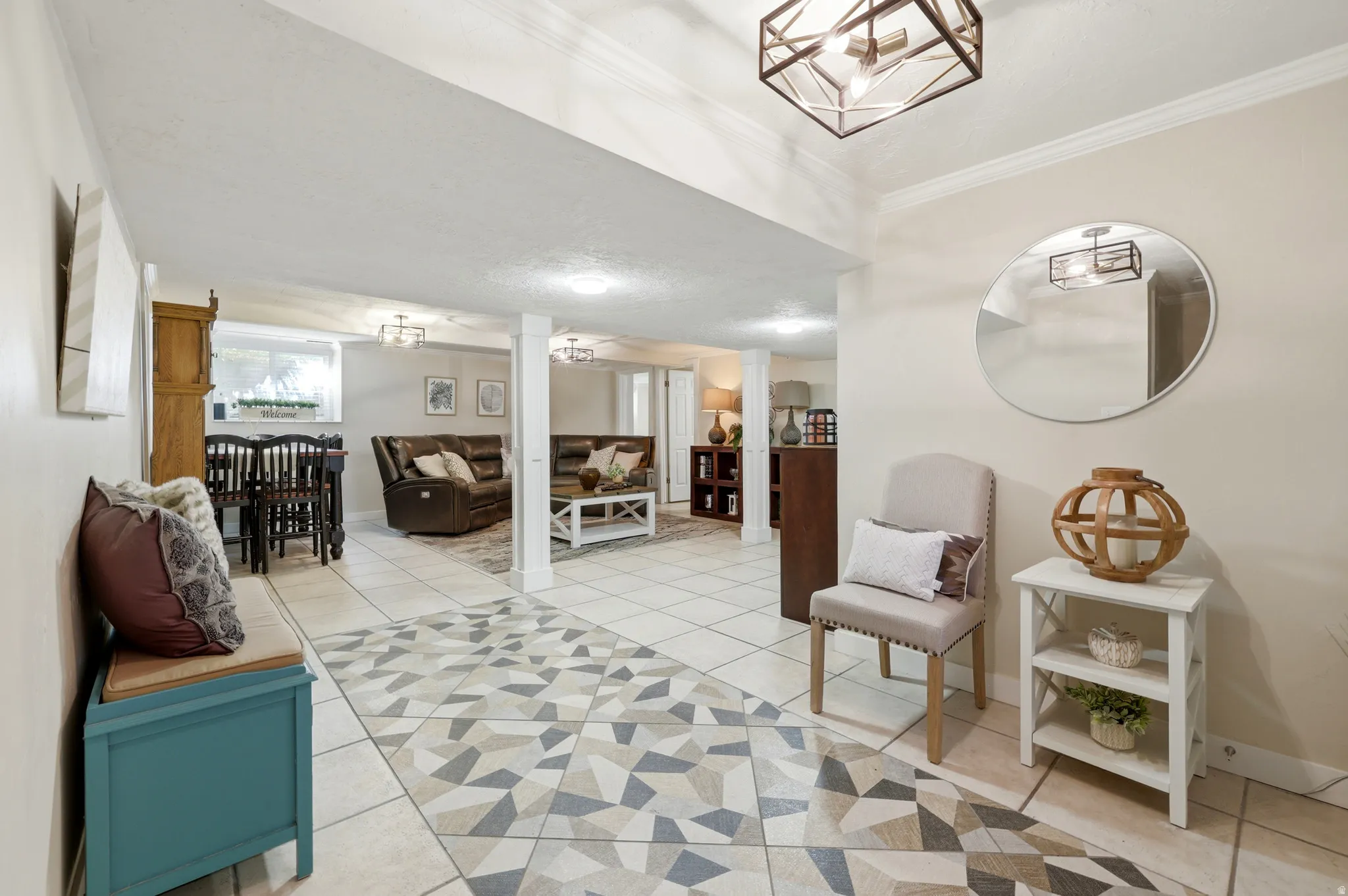 Expansive finished lower level featuring tile flooring, geometric accent tile, recessed lighting, and crown molding