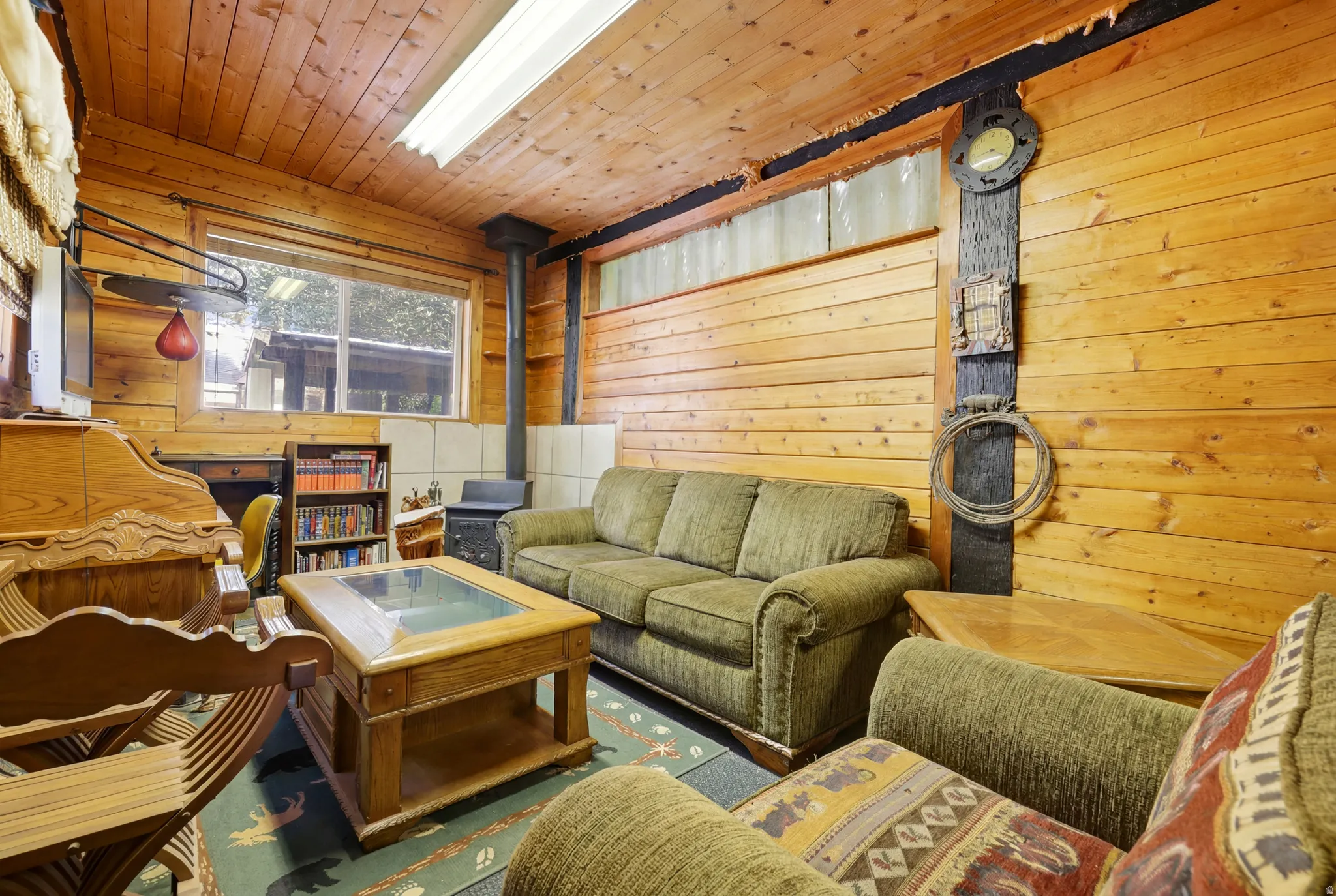 Paneled room featuring horizontal wood-finish walls and ceiling