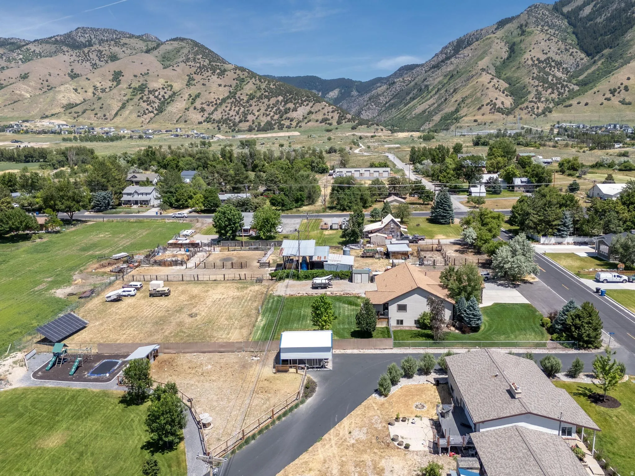 Expansive property featuring mountainous terrain, a paved road, and substantial land area