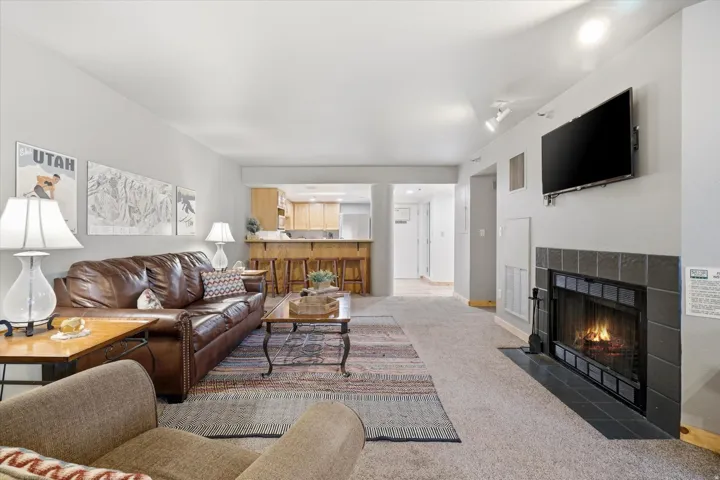 Open-concept living area with neutral wall tones and recessed lighting