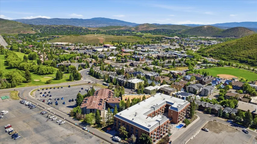 Aerial perspective showcasing a vibrant community surrounded by rolling hills and lush greenery