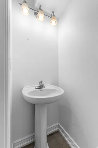 White pedestal sink with a chrome two-handle faucet