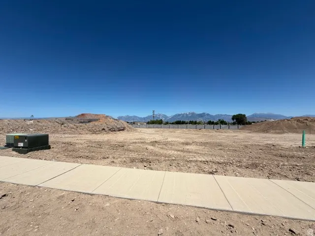 Expansive undeveloped lot with a newly installed concrete sidewalk