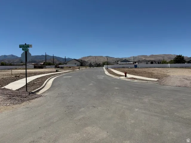 Paved street with concrete sidewalks and a red fire hydrant