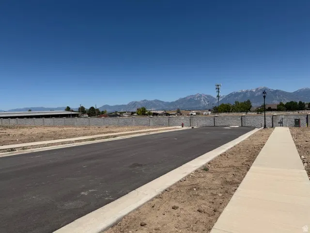 Paved roadway with concrete sidewalks and a retaining wall