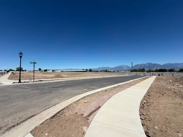 Newly paved street with concrete sidewalk and street lamp