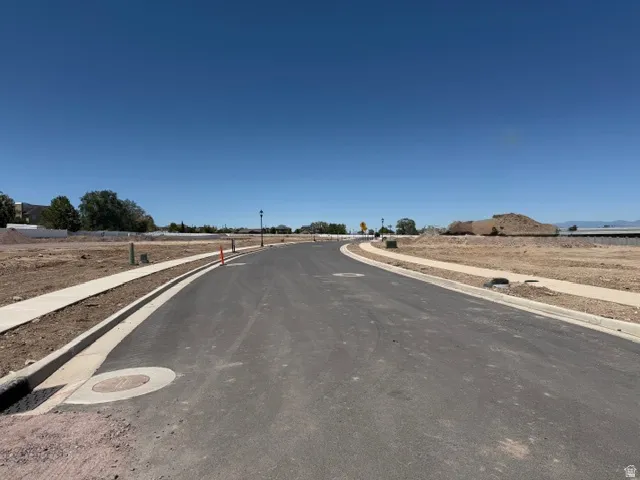 Paved asphalt street with concrete curbing and sidewalks
