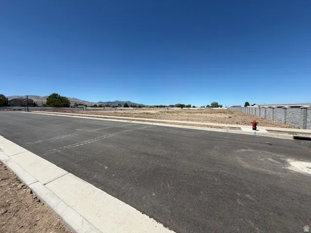 Newly paved asphalt street with a concrete curb and gutter system