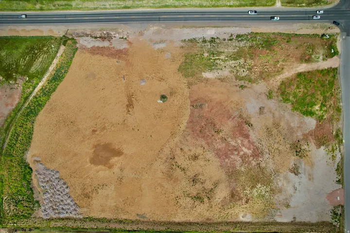 Expansive undeveloped land featuring varied terrain and direct road frontage