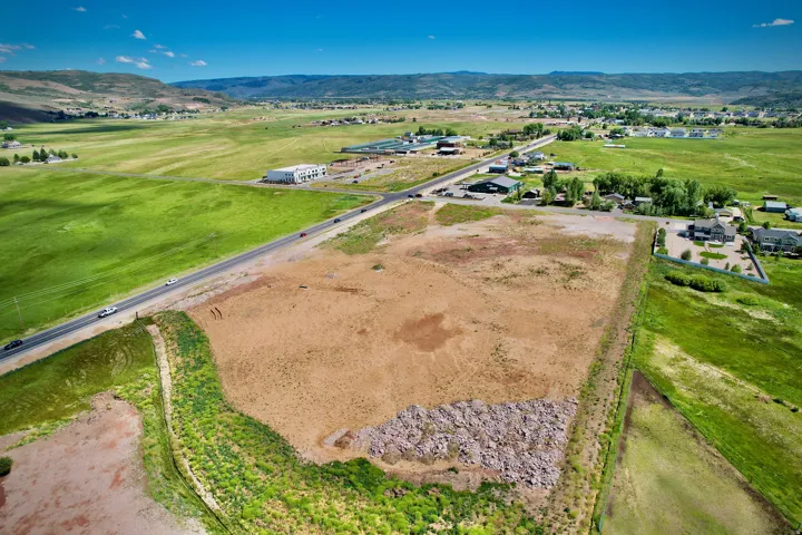 Expansive parcel featuring a mix of cleared land and natural ground cover
