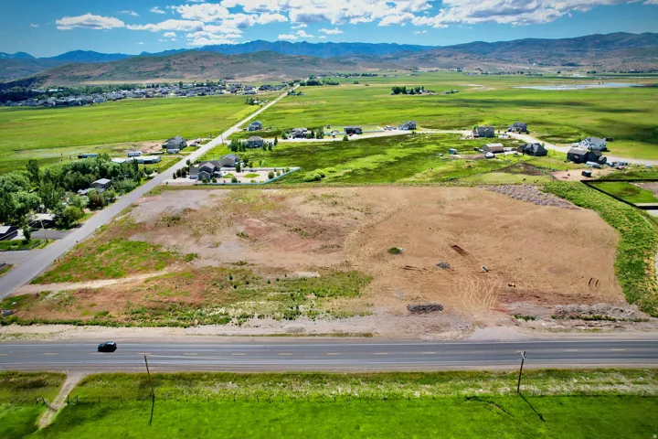 Expansive land parcel featuring direct road frontage and mountain scenery