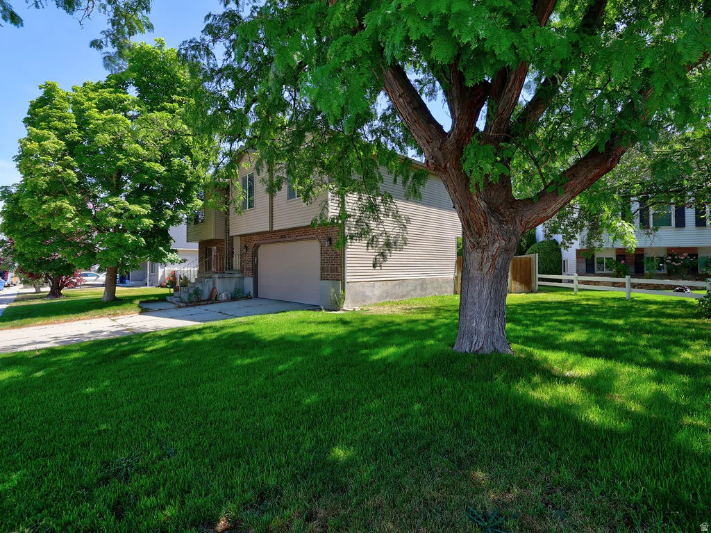 Front exterior featuring a two-story design, an integrated garage, and a brick facade accent