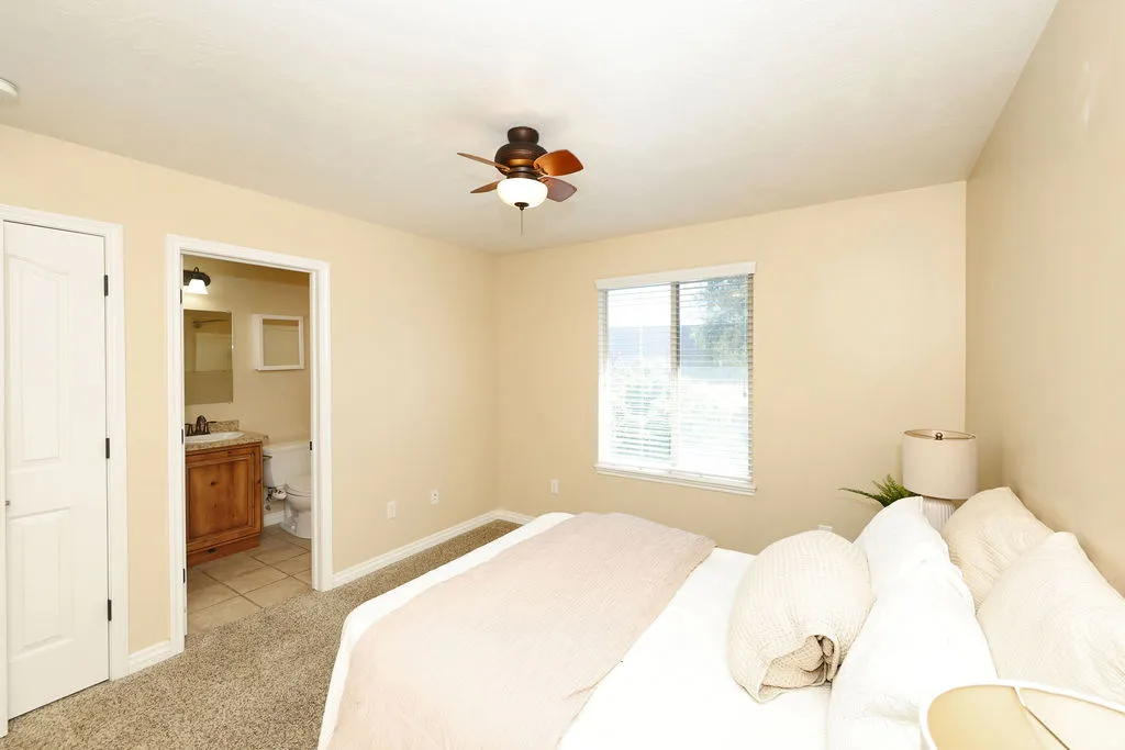 Bedroom featuring neutral-toned walls, recessed lighting, and a ceiling fan with integrated light fixture