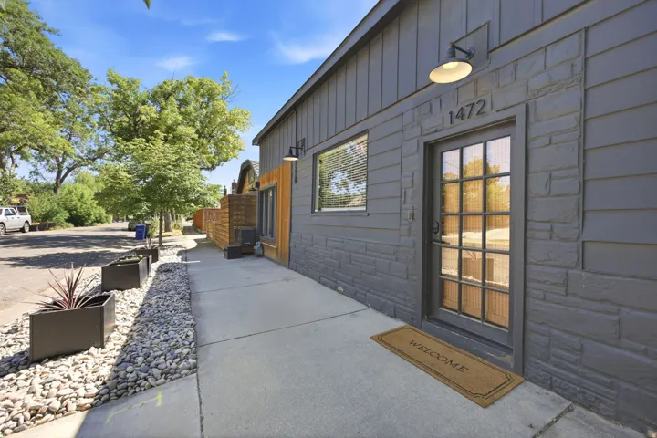 Gray exterior with a mix of vertical siding and stone-look paneling
