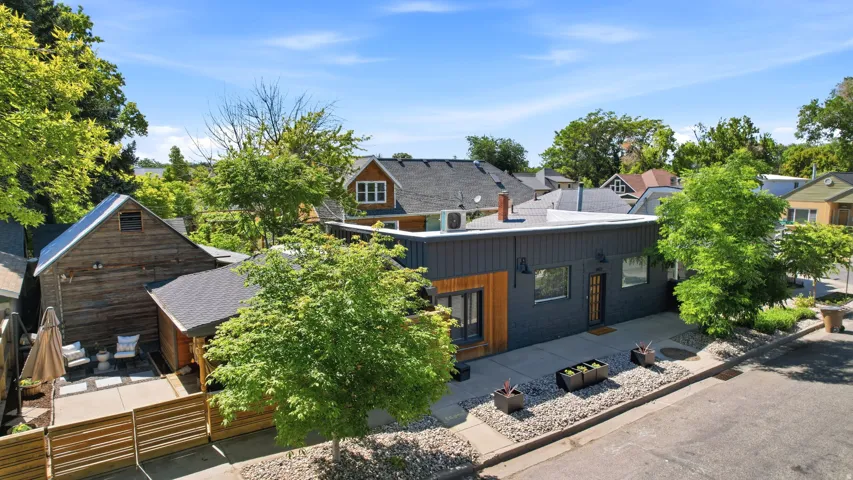 Modern exterior with dark vertical siding and wood-panel accents