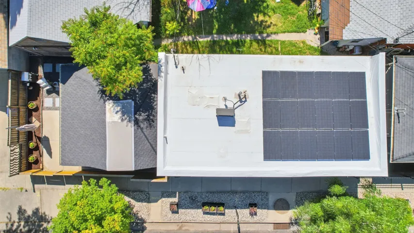 Overhead property perspective showcasing a flat roof with solar panel array
