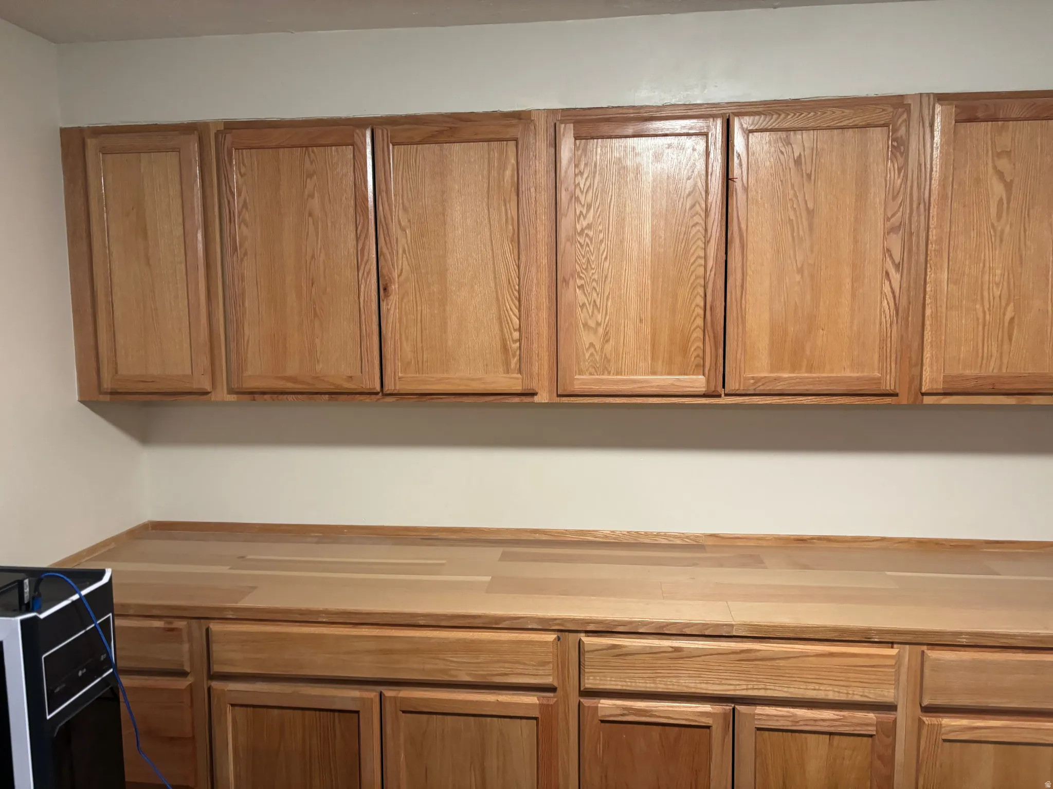 Extensive wood cabinetry and wood-finish countertops provide abundant storage and workspace