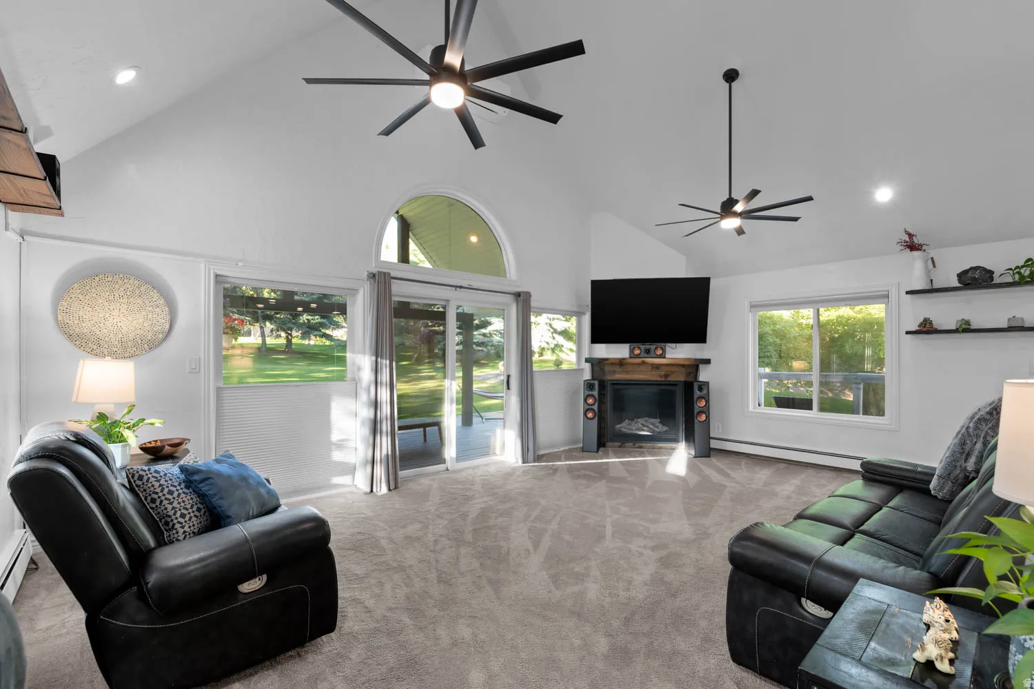 Spacious living area featuring a vaulted ceiling and recessed lighting