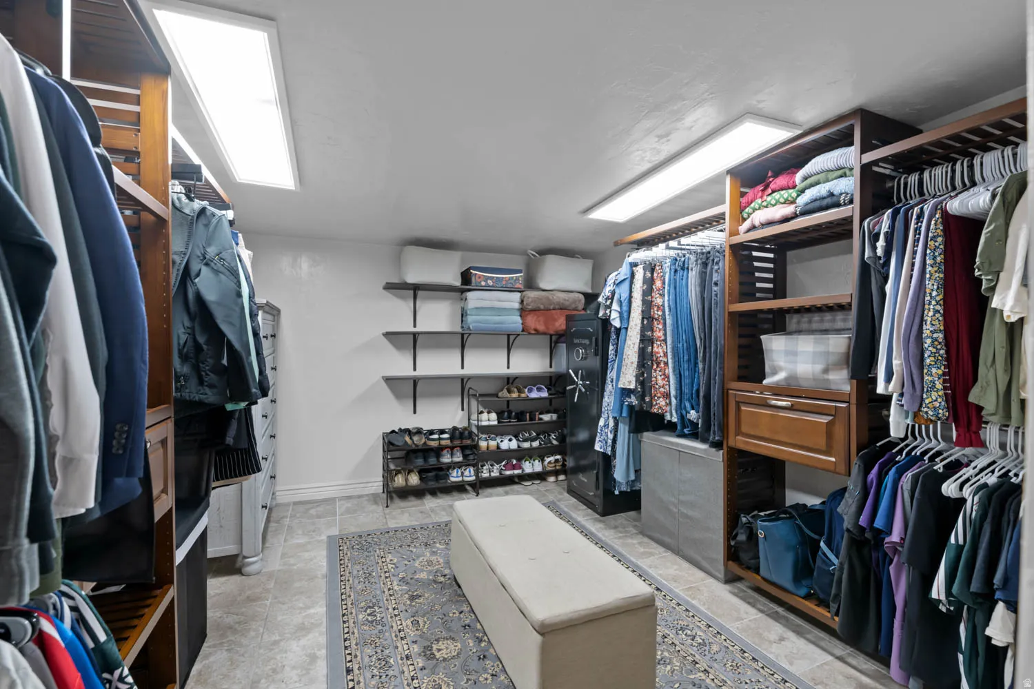Custom closet system featuring dark wood-finish shelving and integrated hanging rods