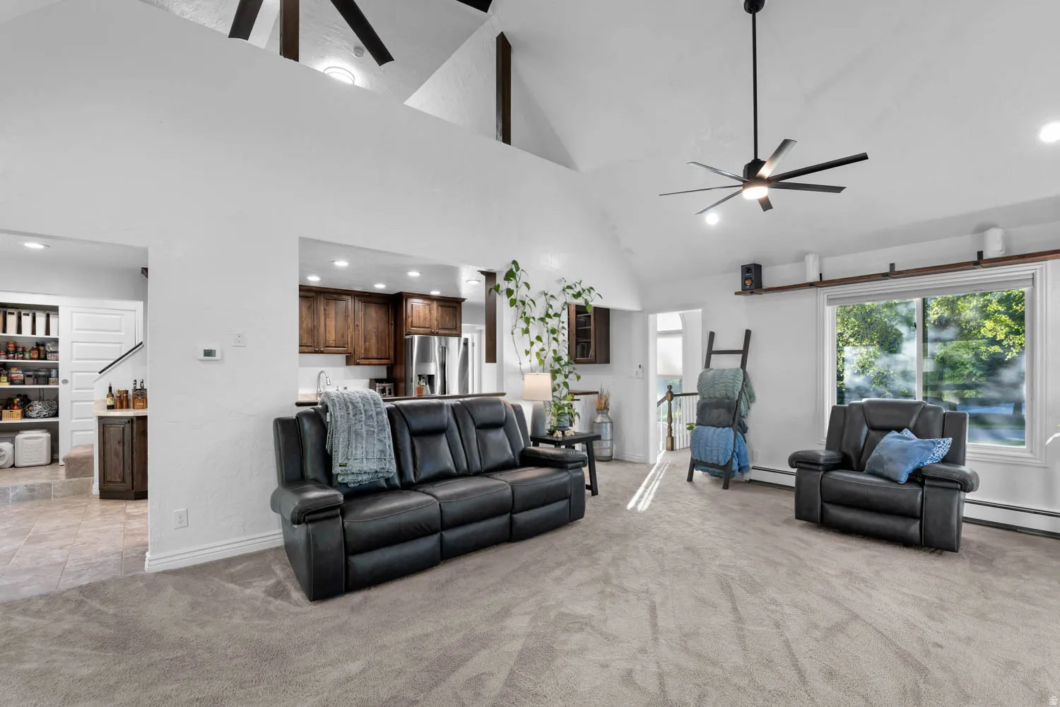 Vaulted ceiling with exposed beams, recessed lighting, and a modern ceiling fan