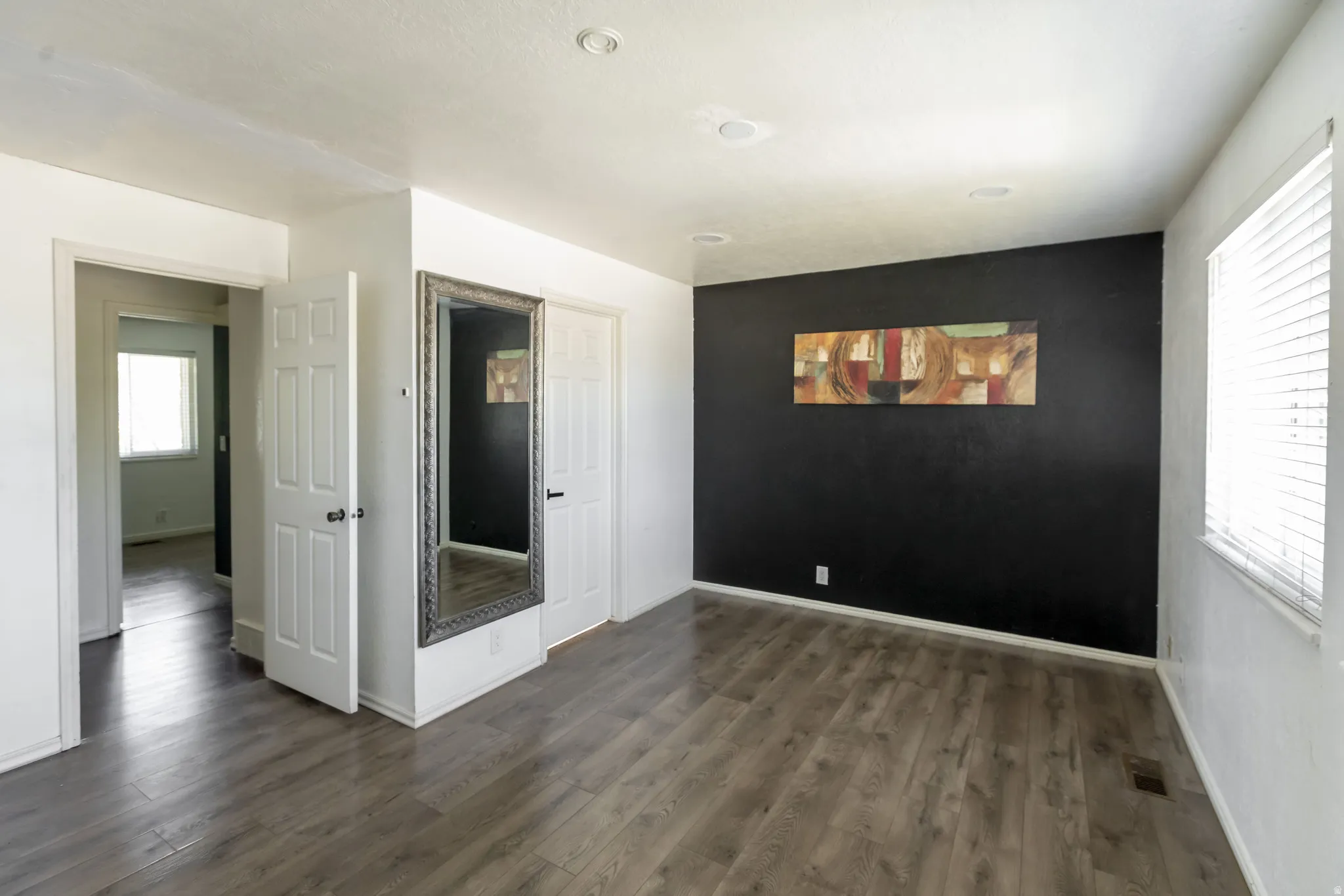 Interior room featuring wood-finish flooring and recessed ceiling lights
