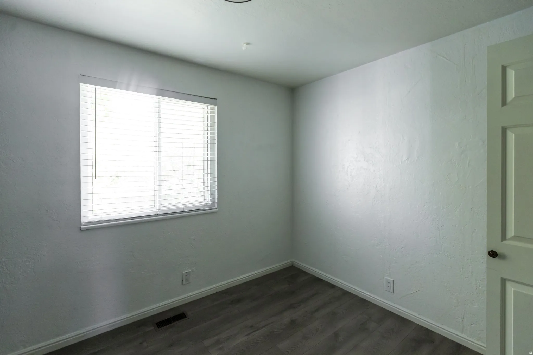 Neutral wall color with wood-finish flooring