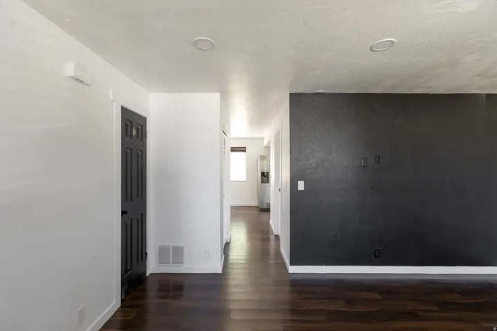 Interior space featuring wood-finish flooring, white walls, and recessed lighting