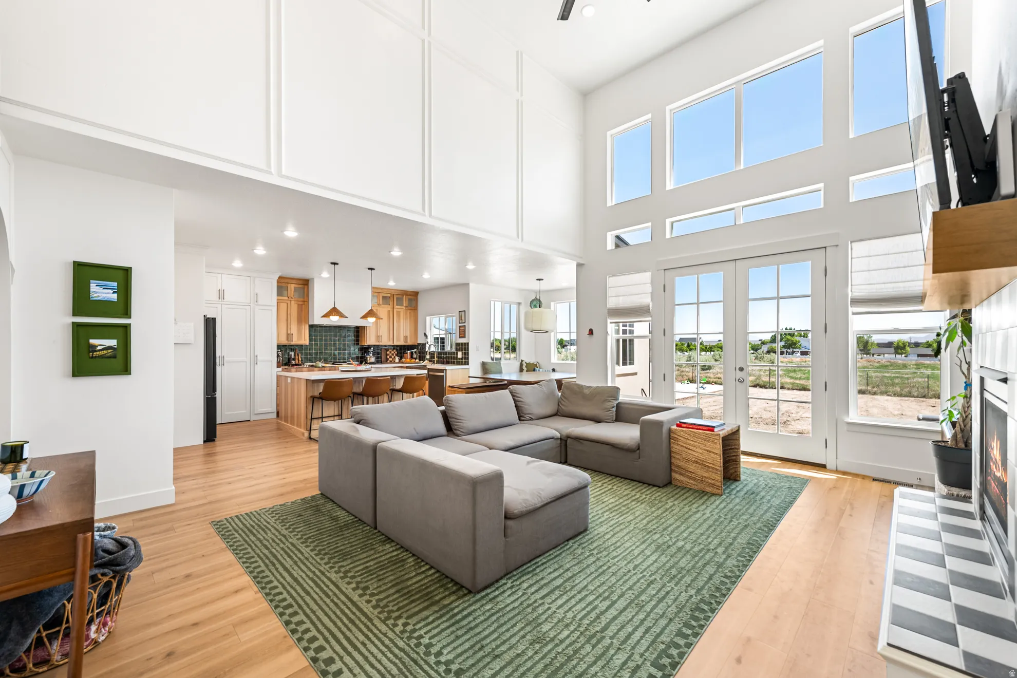 Expansive living area featuring soaring ceilings and abundant natural light