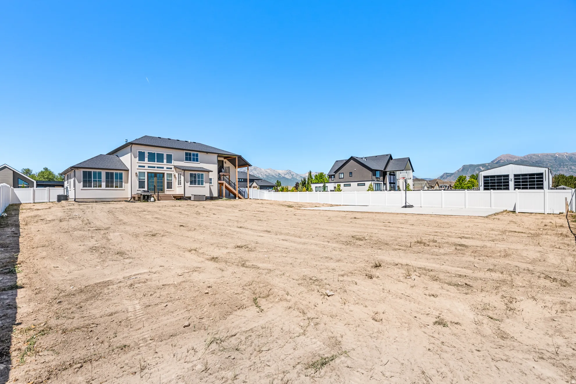 Expansive rear yard with a perimeter fence, offering a blank canvas for customization