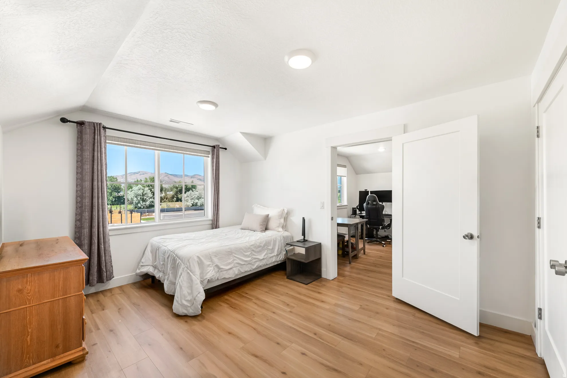 Bright room with wood-finish flooring and a large window