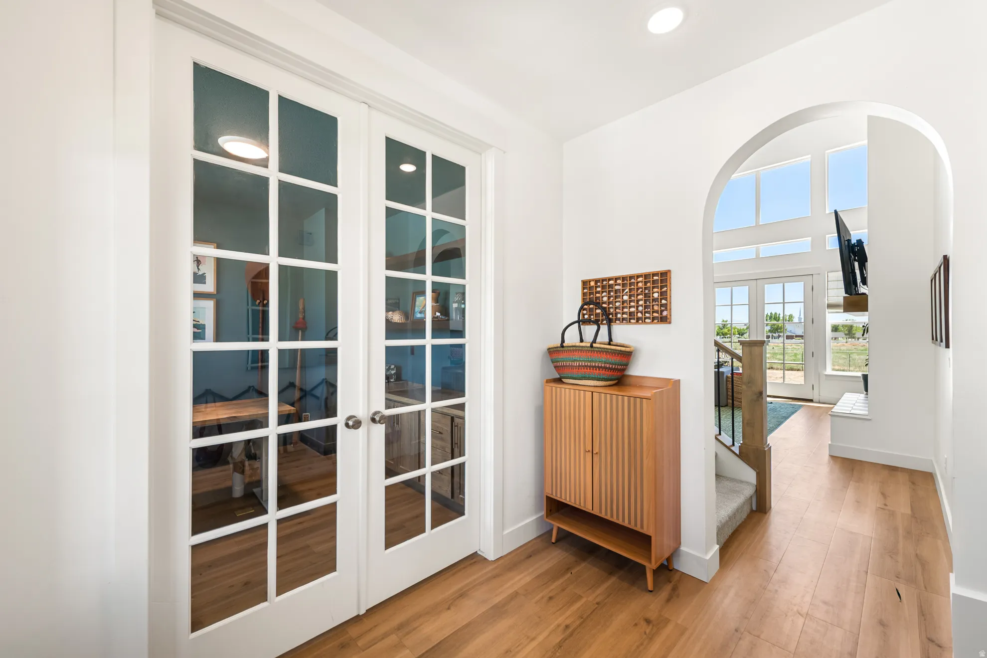 French doors with multiple lites open to an interior space