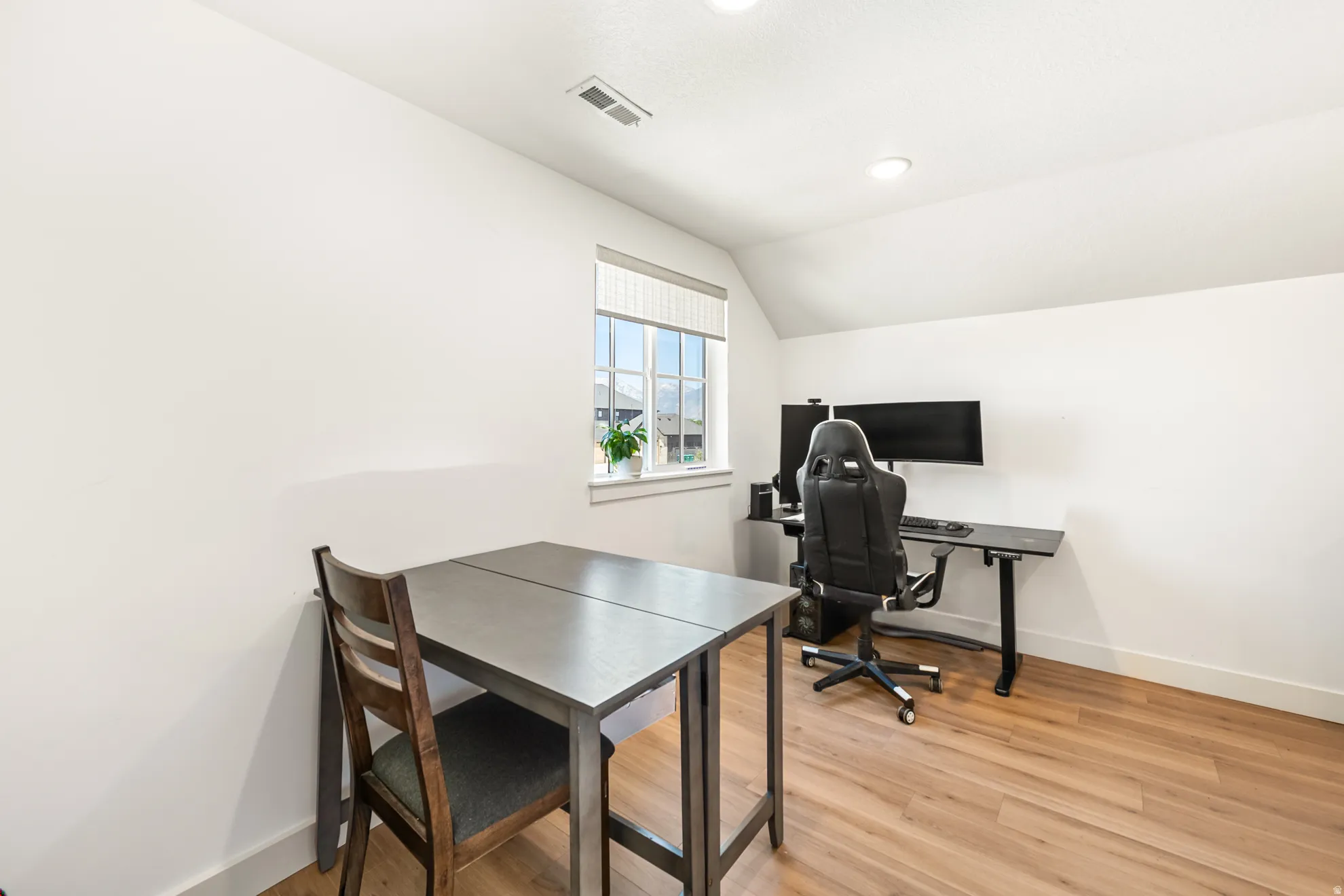 Bright room featuring wood-finish flooring and white walls