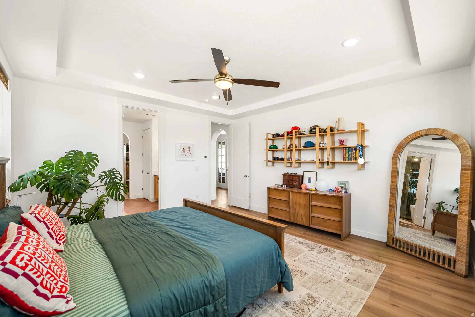 Bedroom featuring wood-finish flooring, a tray ceiling, and recessed lighting