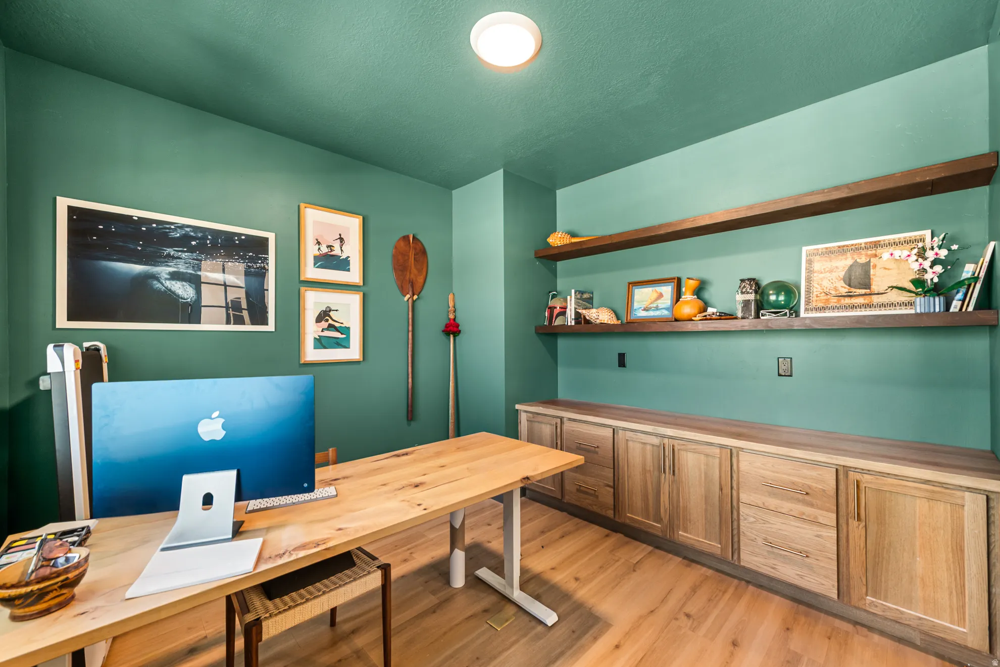Custom built-in cabinetry with a light wood finish provides extensive storage