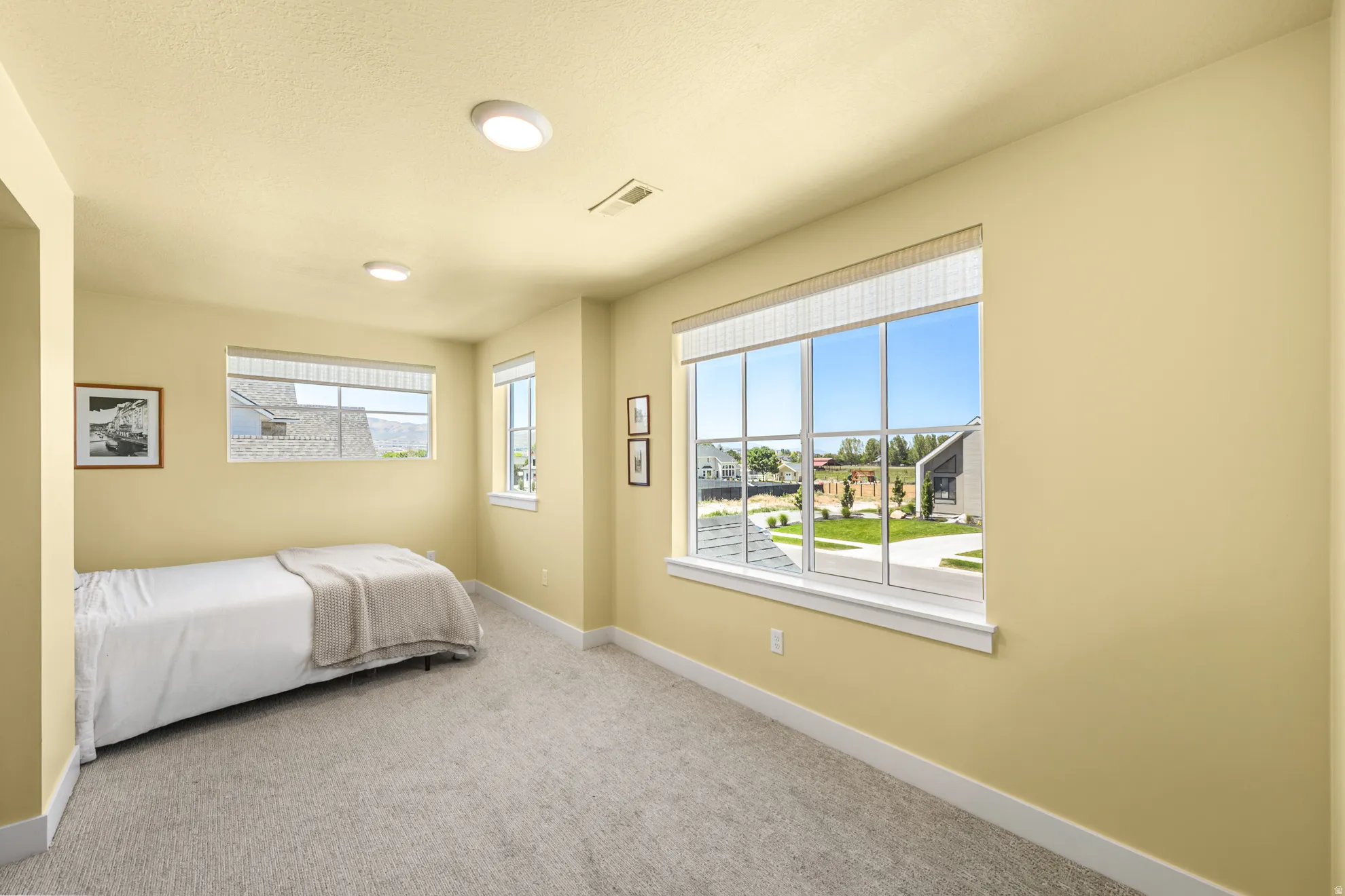 Carpeted room featuring multiple windows, recessed lighting, and pale yellow walls