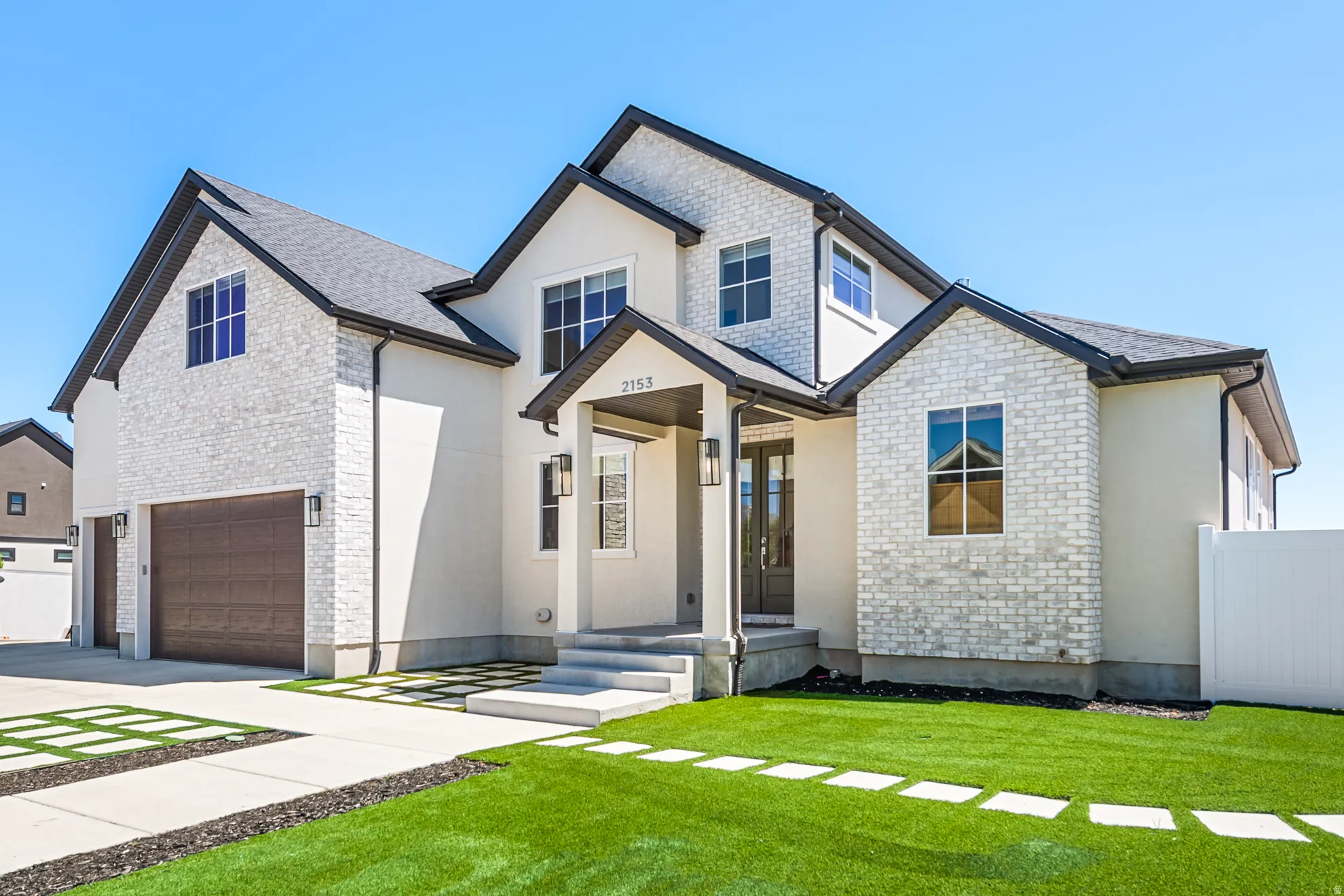 Modern exterior featuring white brick and stucco finishes