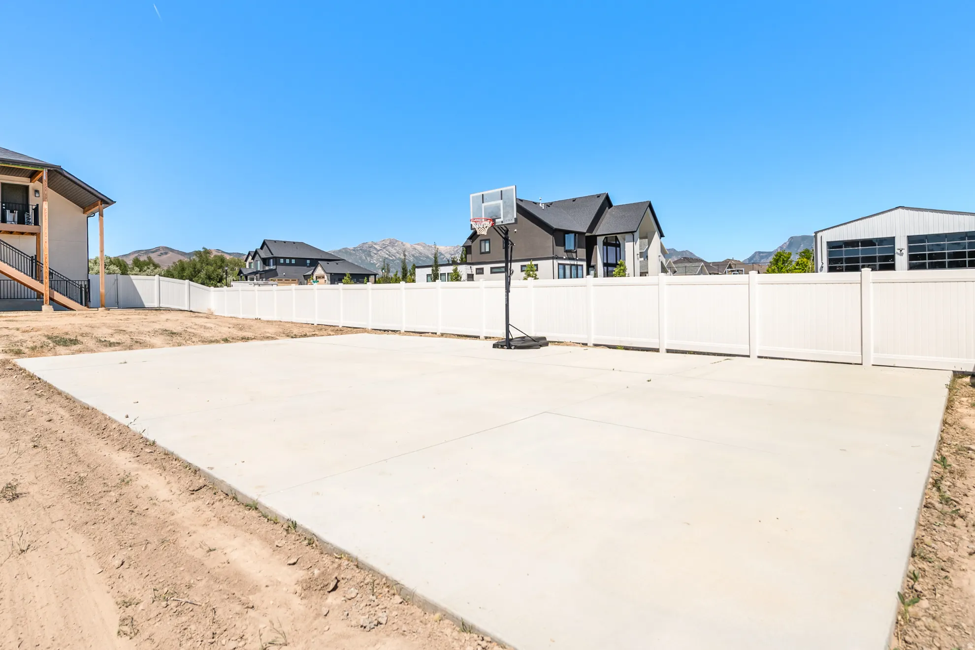 Expansive concrete pad with surrounding white panel fencing