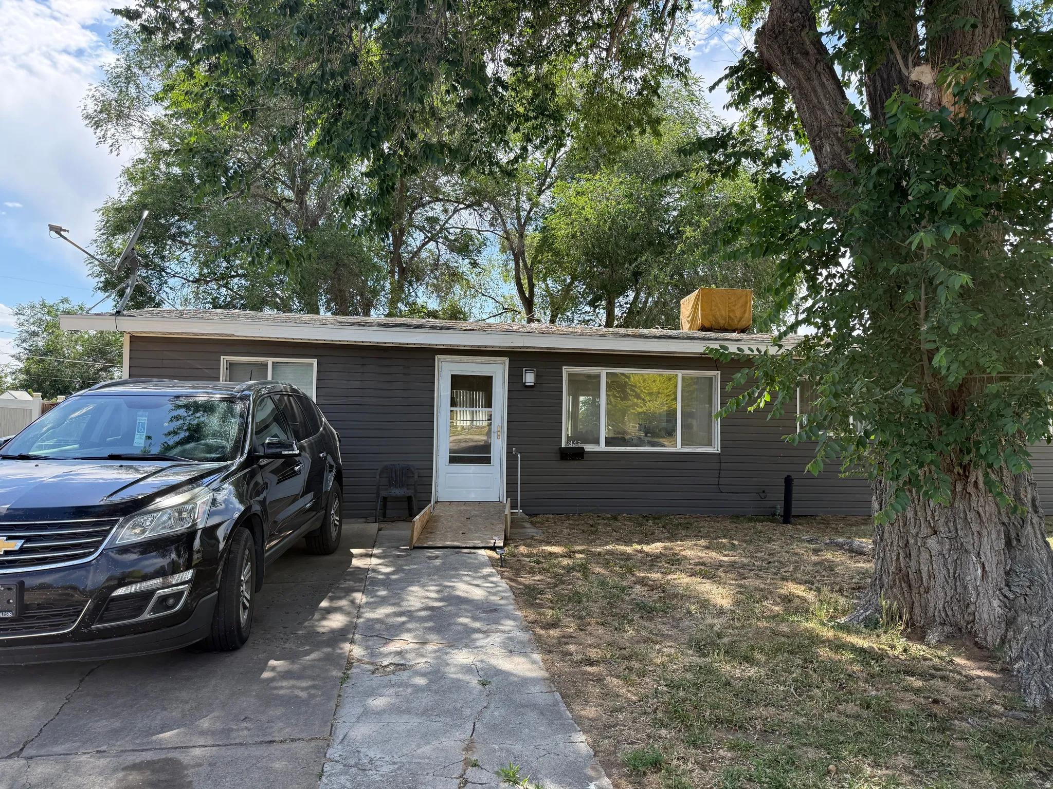 Single-story residence featuring horizontal dark gray siding and white trim