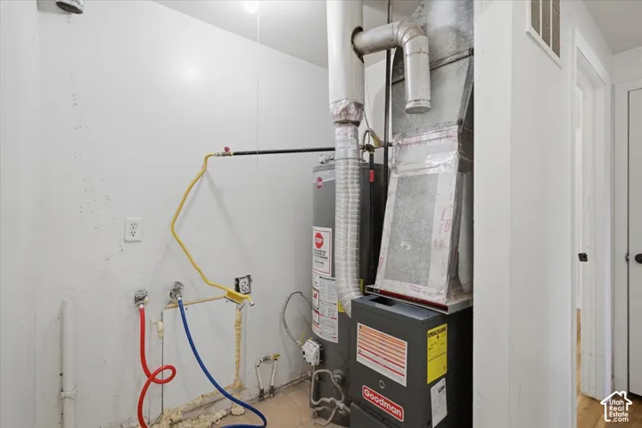 Utility area featuring a water heater and furnace