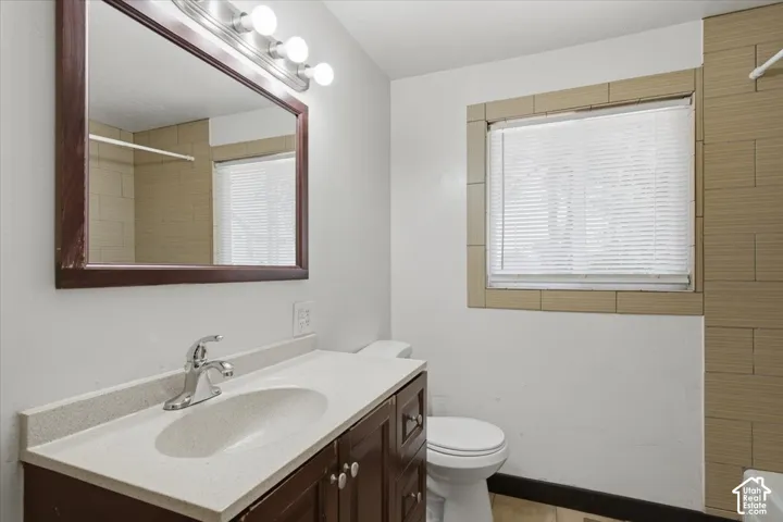 Dark wood-finish vanity with an integrated sink and chrome faucet
