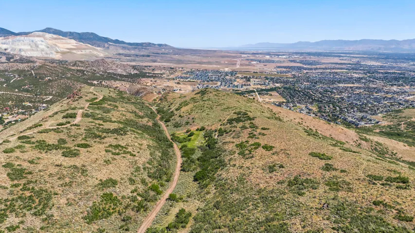 Expansive mountainous terrain with a visible dirt path