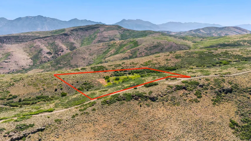 Expansive land parcel featuring varied topography and natural vegetation