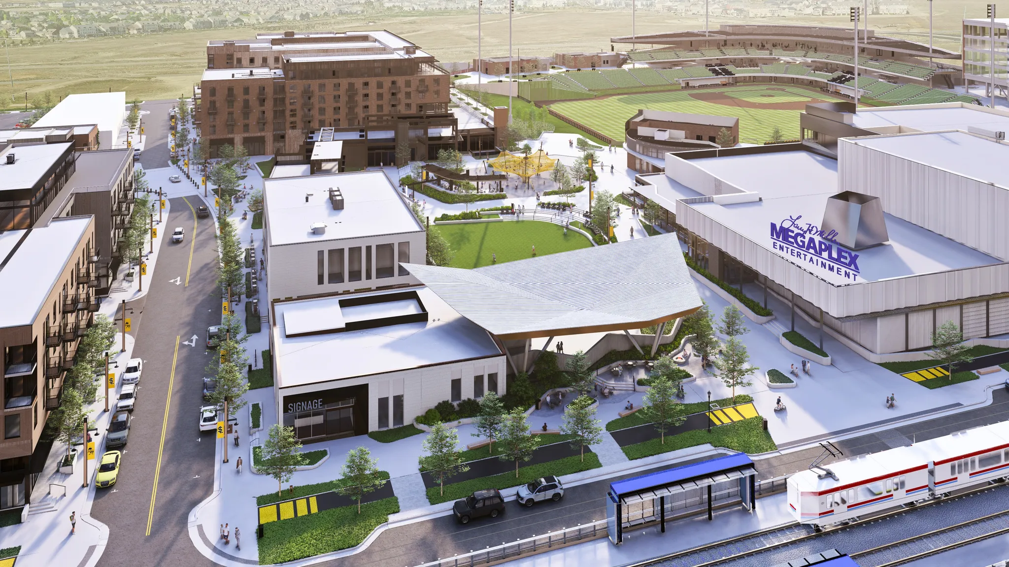 Urban development featuring multi-story buildings, a baseball stadium, a large entertainment complex, green spaces, and a train station with multiple tracks