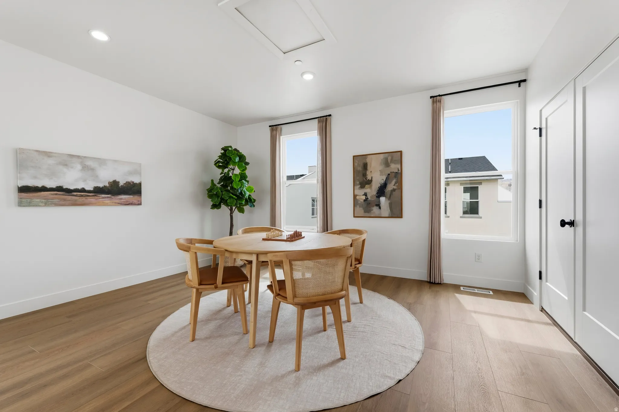 Bright interior space featuring wood-finish flooring, white walls, and recessed lighting